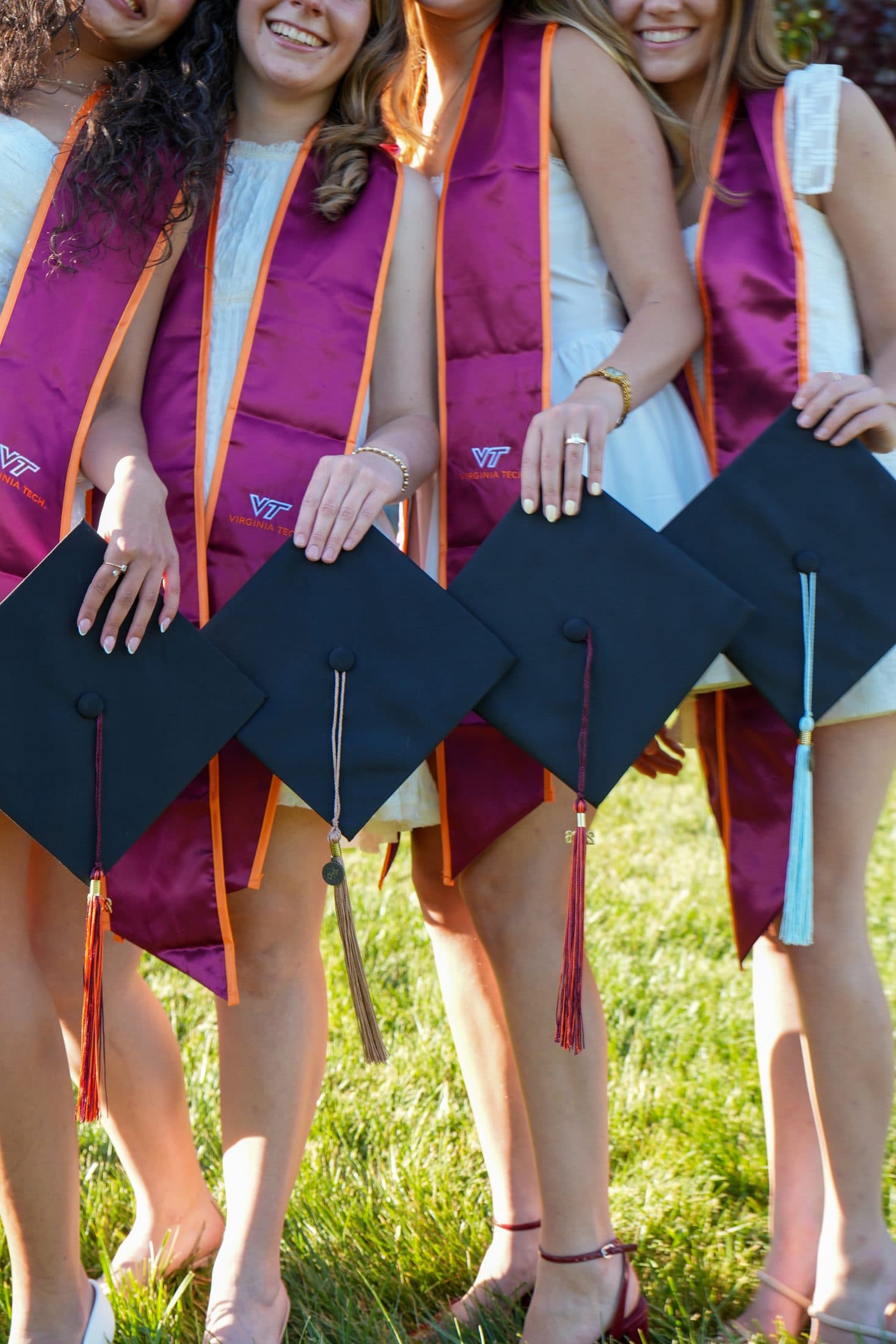 A close crop of maroon stoles and caps worn shoulder to shoulder