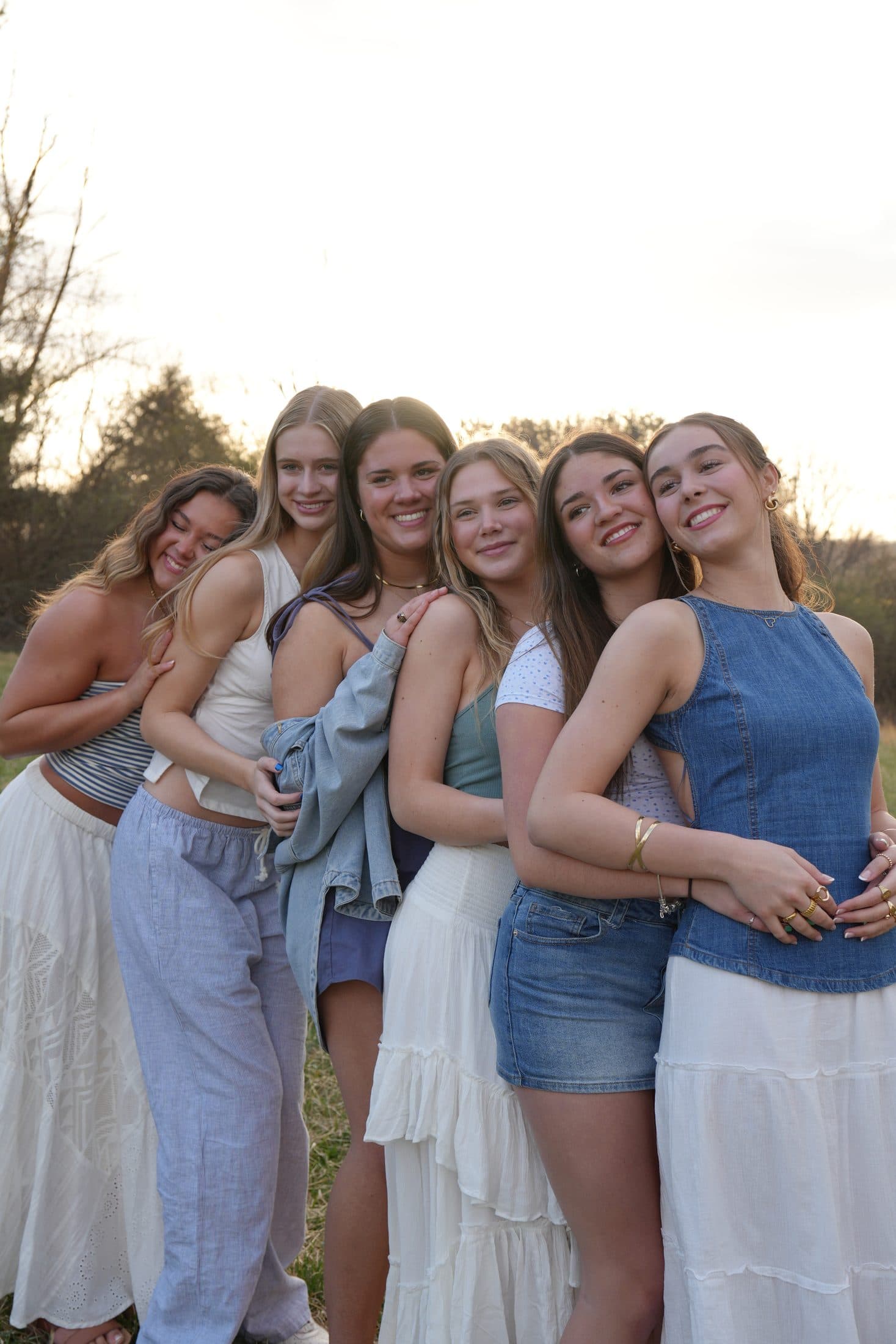 Six seniors laughing together with the blue ridge mountains behind them