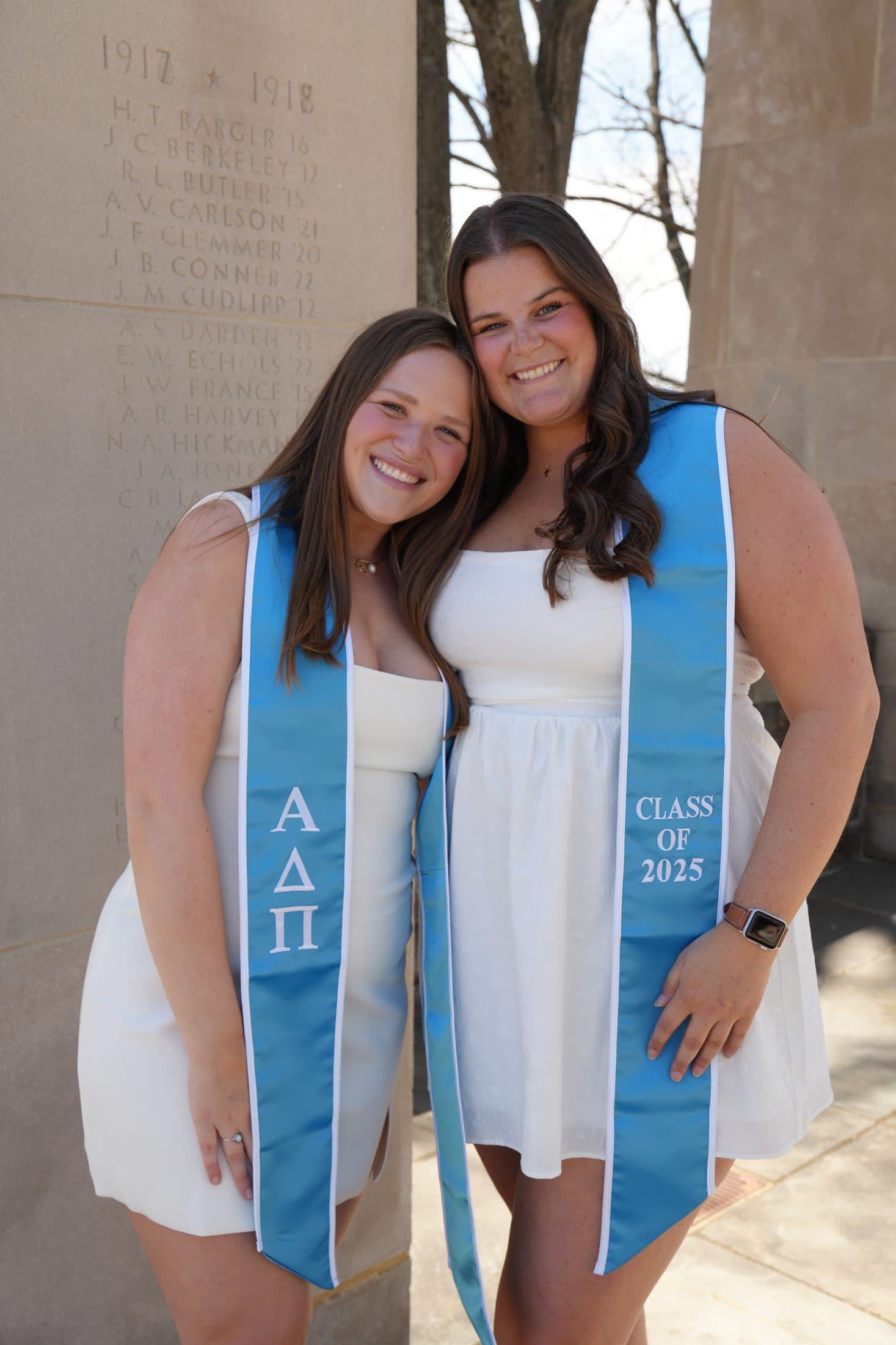 Two sisters in blue sorority stoles at the War Memorial in their graduation year