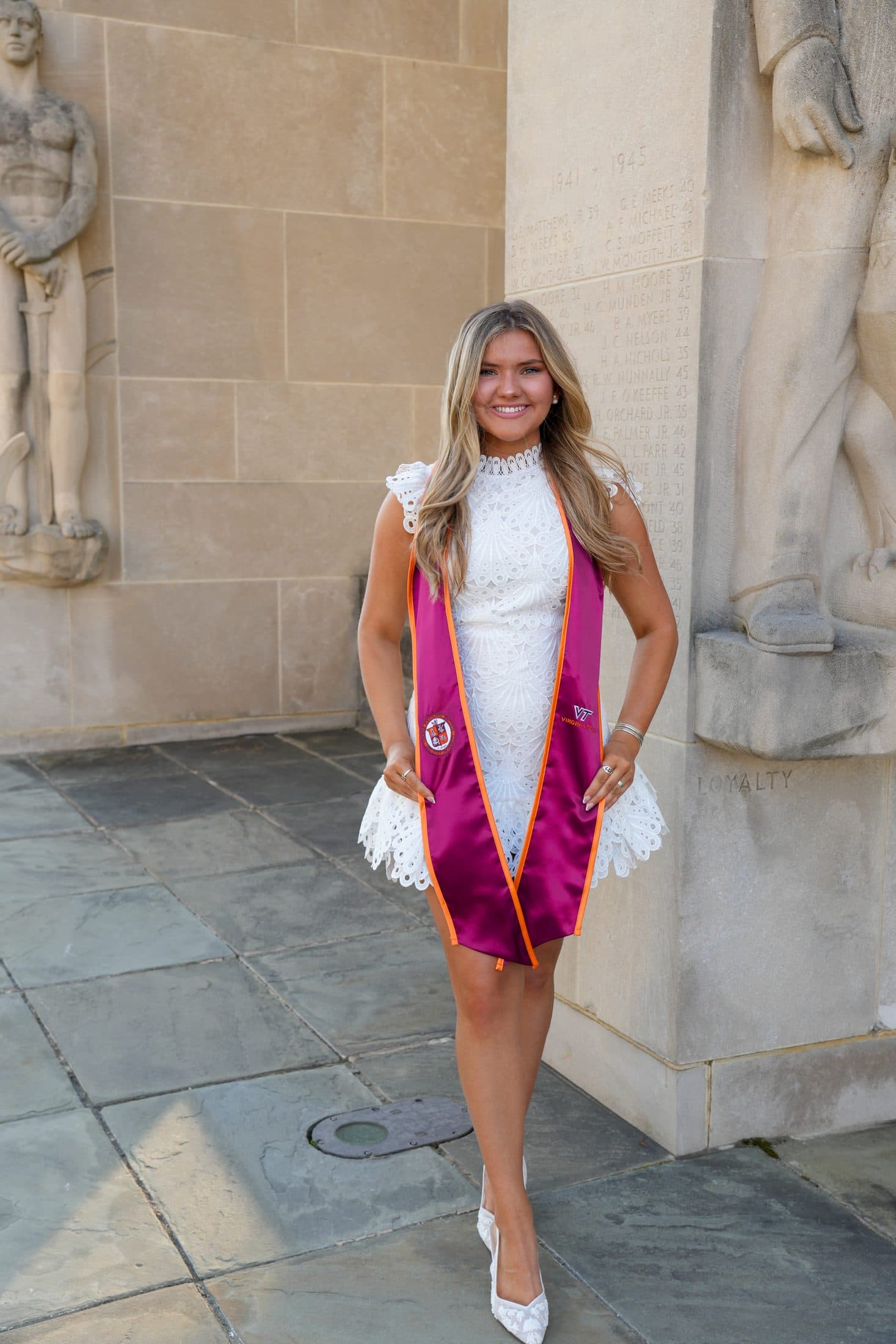 A senior standing among the limestone pylons of the War Memorial