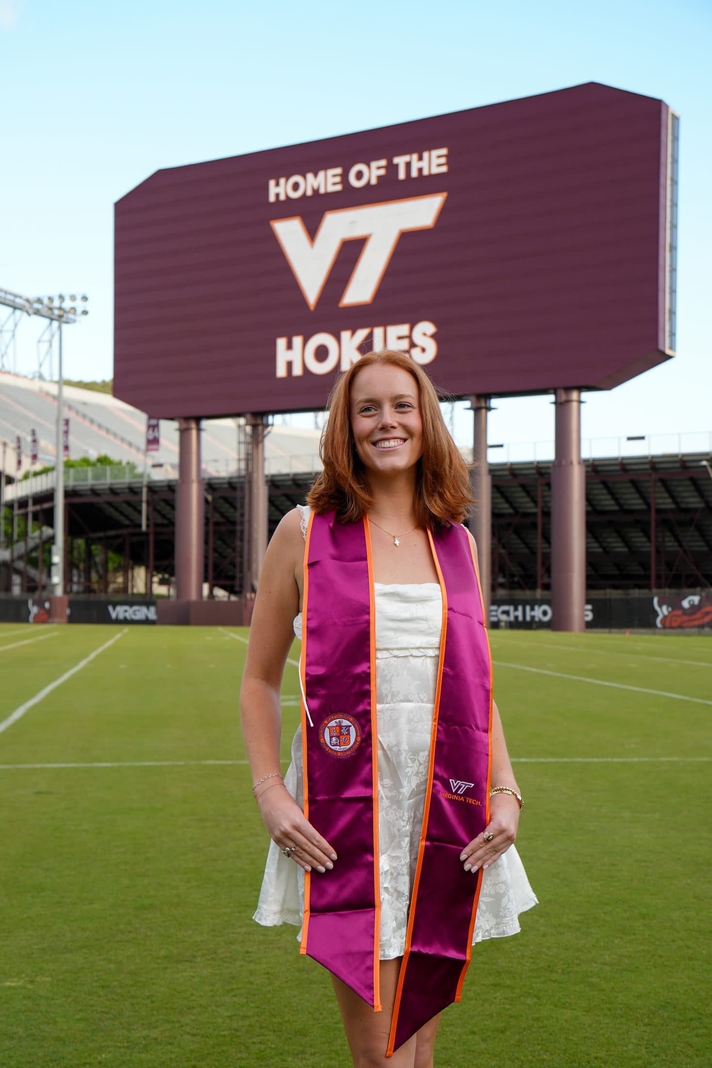 A close study of platform heels and a graduation cap held at her side
